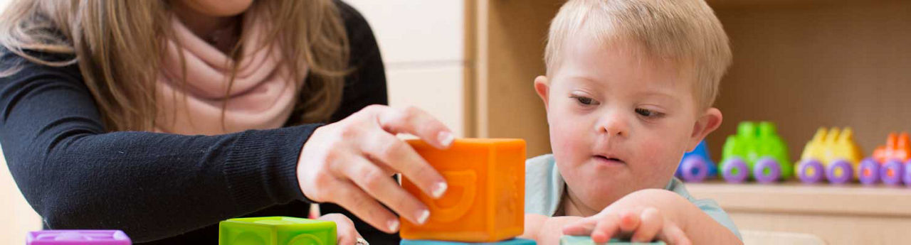 Stanford Medicine Children's Health Development Pediatrics therapist with young child playing with blocks