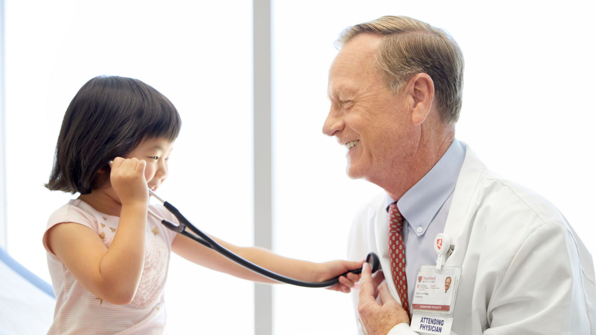 Toddler listening to doctor's heart