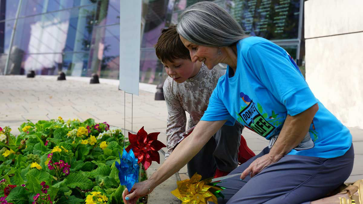 Gerri James, RN, and Everett planting pinwheels – representing a life-saving transplant.